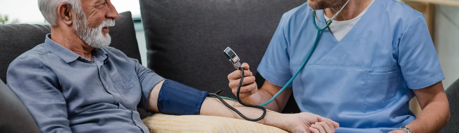 Healthcare professional measuring a patient's blood pressure during a home visit
