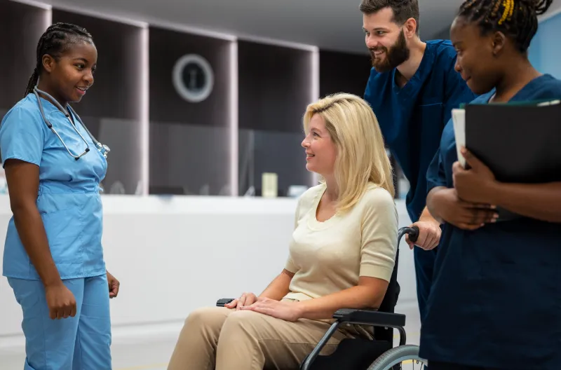Care staff supporting a seated resident